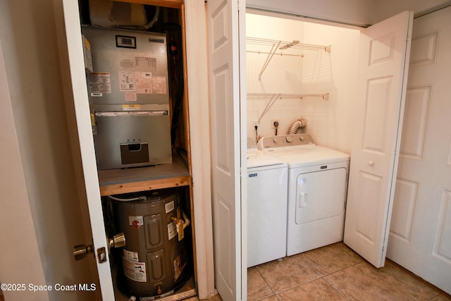 laundry area featuring heating unit, light tile patterned flooring, and independent washer and dryer