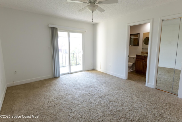 carpeted empty room featuring ceiling fan and a textured ceiling