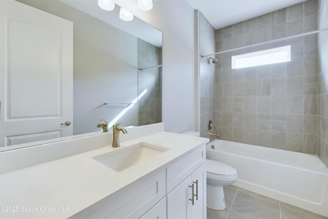 full bathroom featuring vanity, tiled shower / bath combo, toilet, and tile patterned flooring