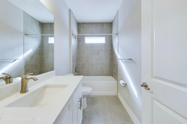 full bathroom featuring tile patterned floors, vanity, tiled shower / bath combo, and toilet