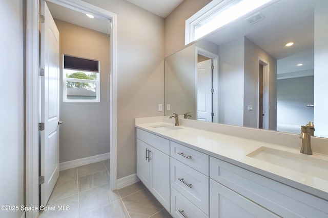 full bathroom featuring double vanity, tile patterned flooring, a sink, and visible vents