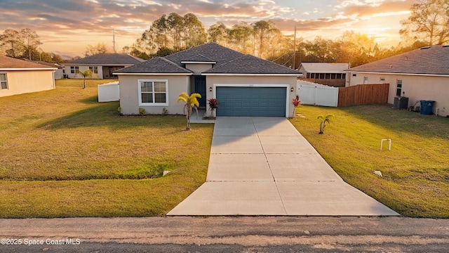535 Giovanni Rd NW, Palm Bay, FL 32907 - view of front facade featuring a garage, stucco siding, concrete driveway, and central AC unit