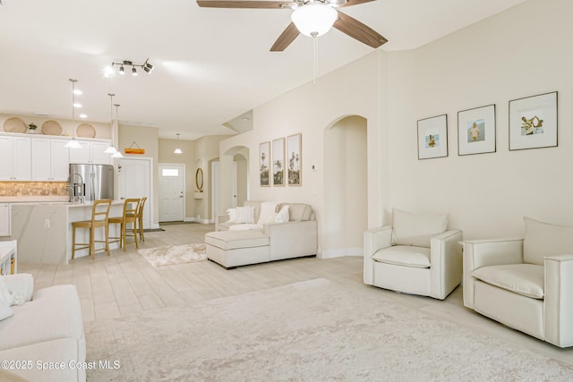 living room with ceiling fan and light hardwood / wood-style floors