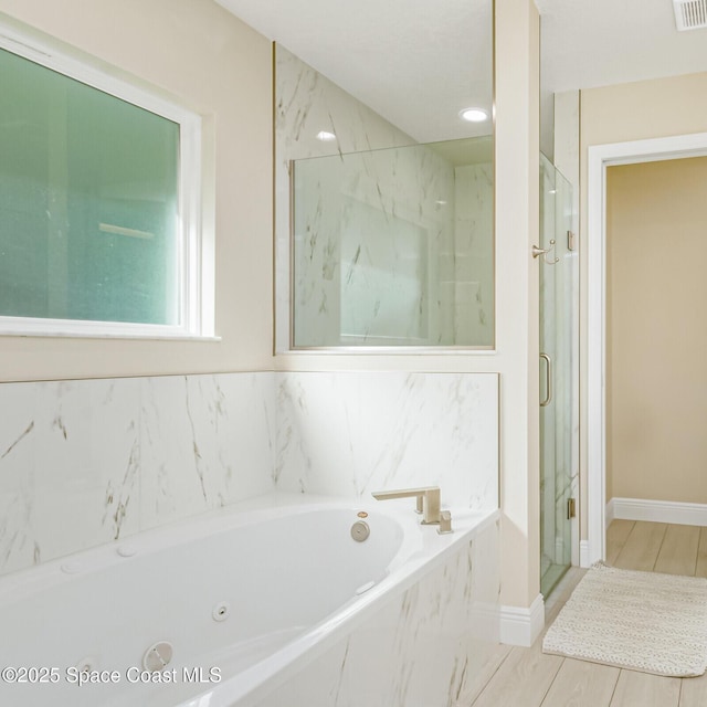 bathroom featuring independent shower and bath