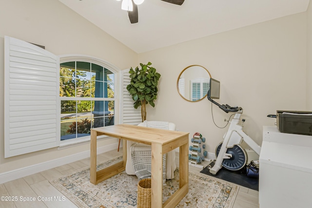 home office with ceiling fan, light hardwood / wood-style flooring, and vaulted ceiling