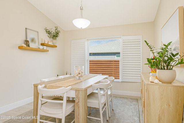 dining room with lofted ceiling