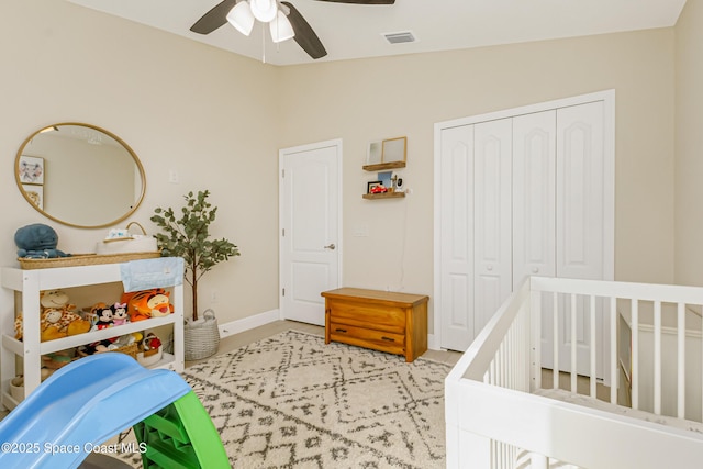 bedroom featuring a nursery area, a closet, ceiling fan, and lofted ceiling