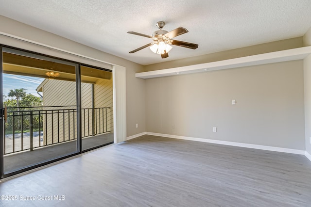 empty room featuring hardwood / wood-style flooring, ceiling fan, and a textured ceiling