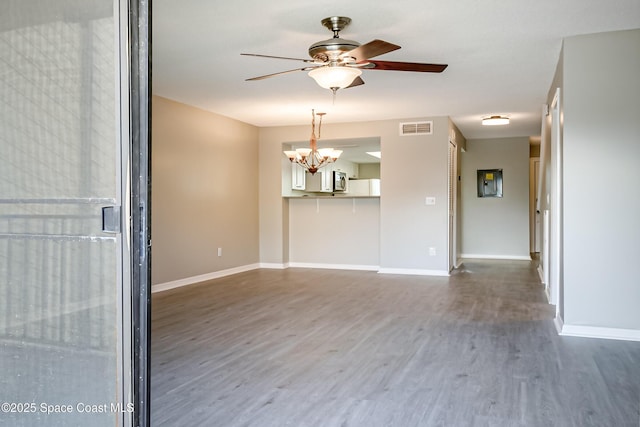 unfurnished room featuring wood-type flooring and ceiling fan with notable chandelier