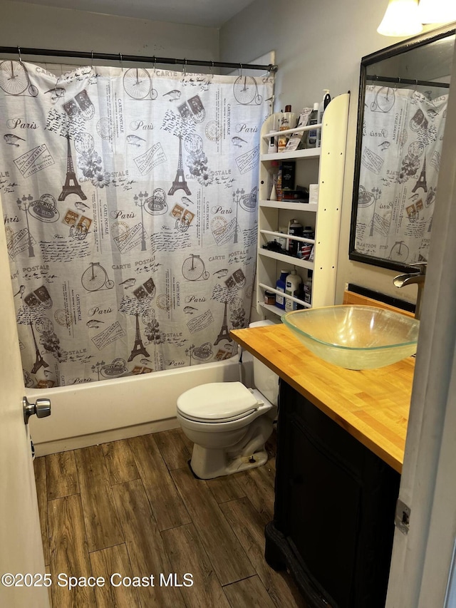 full bathroom featuring hardwood / wood-style floors, vanity, toilet, and shower / bath combo