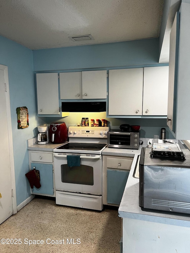 kitchen featuring a textured ceiling and electric range