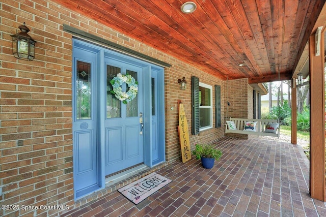 view of exterior entry with a porch