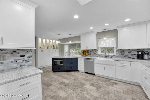 kitchen featuring white cabinetry, stainless steel appliances, and decorative light fixtures