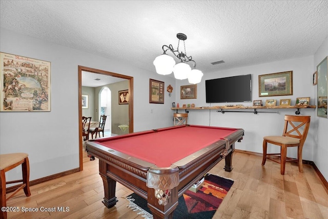 recreation room featuring light wood-type flooring, a textured ceiling, and pool table