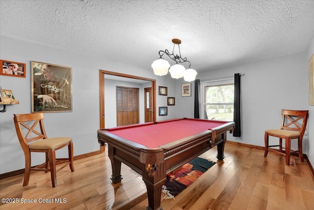 rec room featuring a textured ceiling, light wood-type flooring, and billiards