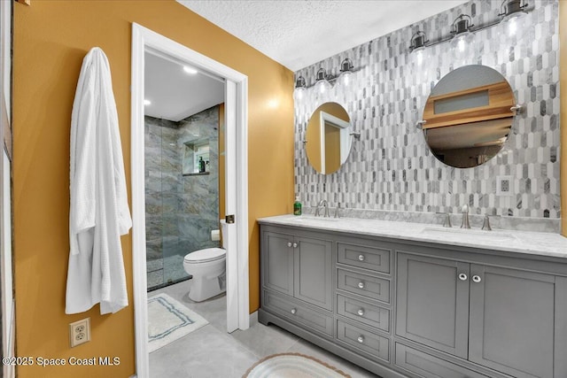 bathroom featuring tile patterned floors, walk in shower, vanity, a textured ceiling, and toilet