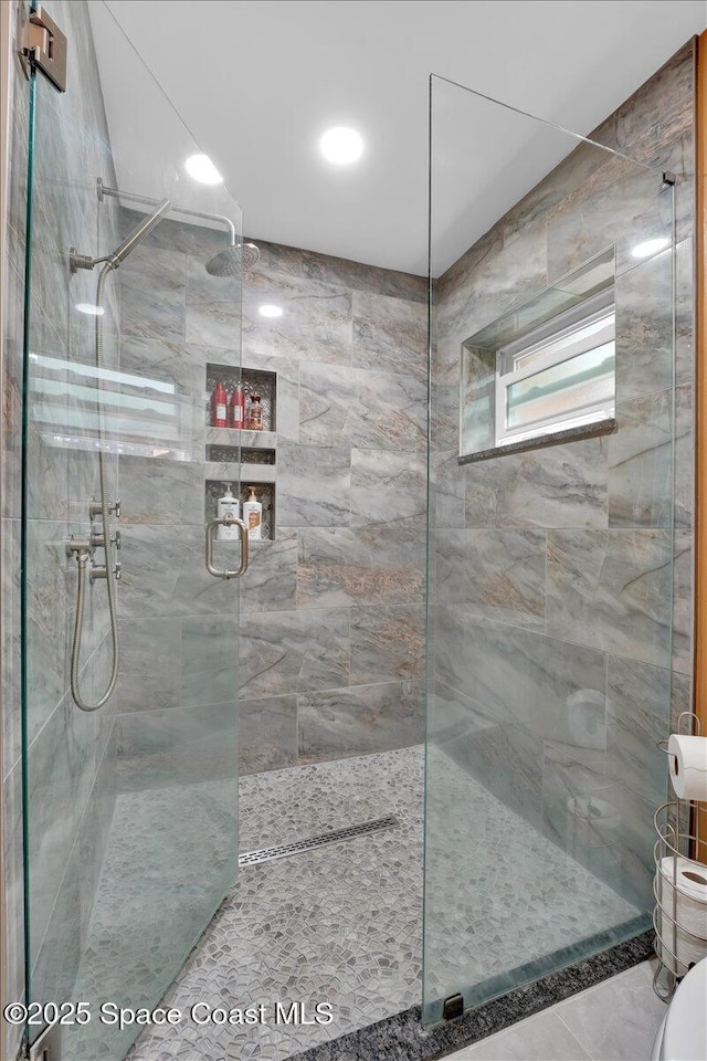 bathroom with an enclosed shower and toilet