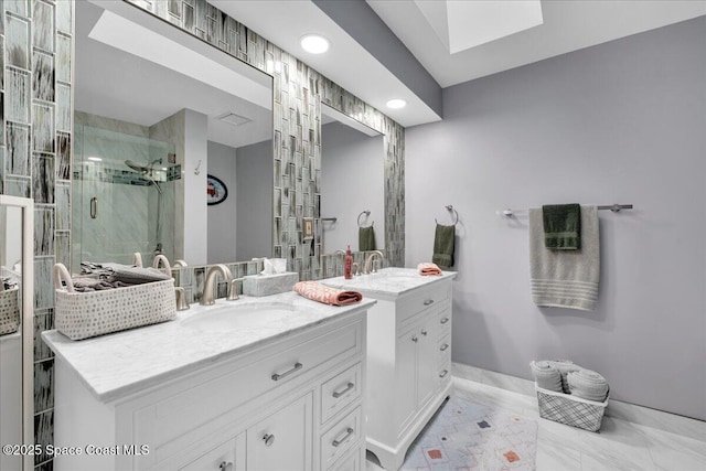 bathroom featuring vanity, a shower with door, and a skylight