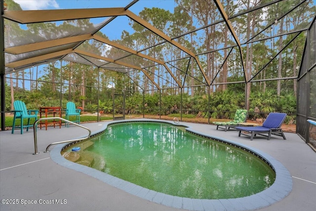 view of swimming pool featuring glass enclosure and a patio area