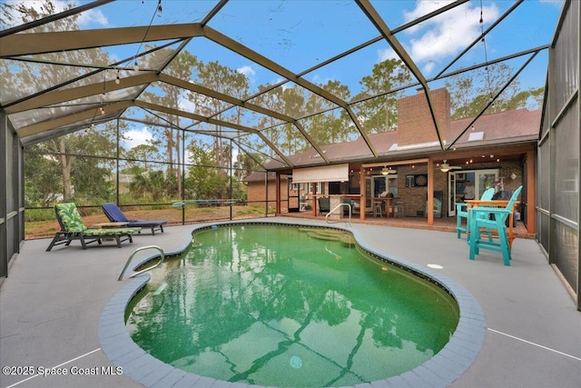 view of swimming pool featuring glass enclosure, ceiling fan, and a patio