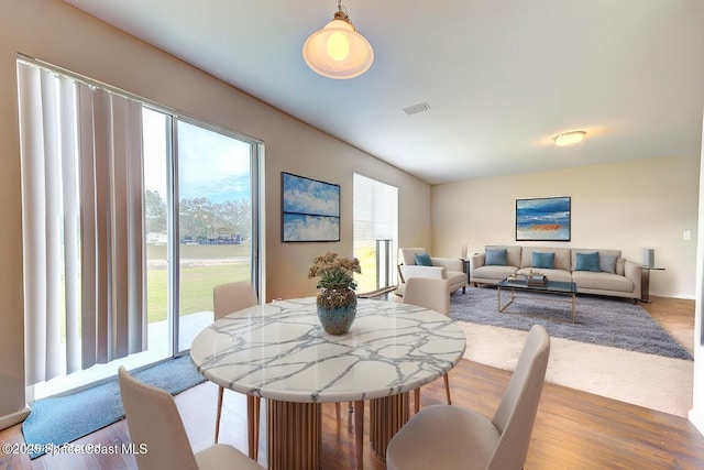 dining room with wood finished floors and visible vents