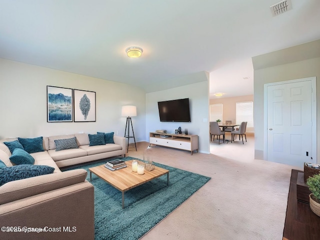 carpeted living area featuring visible vents