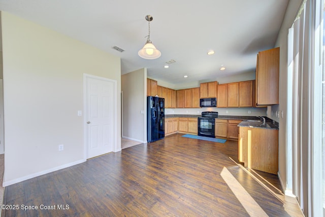 kitchen featuring dark wood-style flooring, visible vents, baseboards, black appliances, and dark countertops