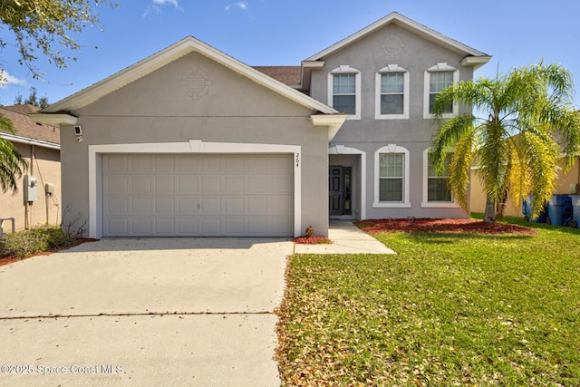 traditional-style home with a garage, a front yard, and stucco siding