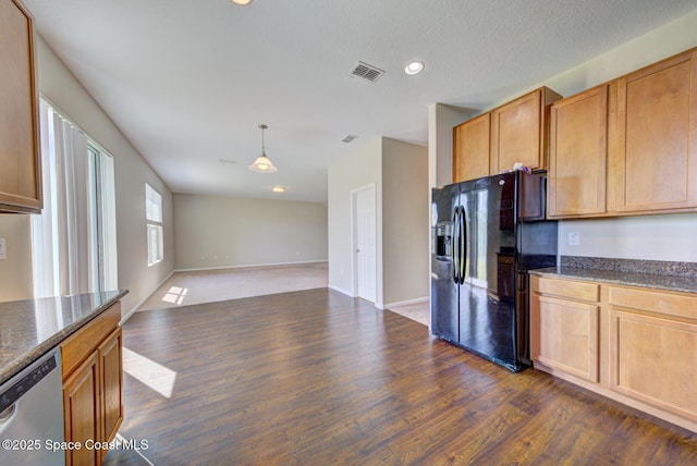 kitchen featuring dark wood-style flooring, visible vents, stainless steel dishwasher, open floor plan, and black fridge