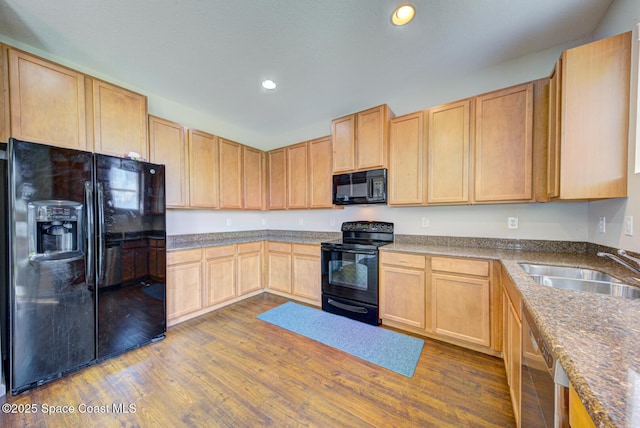 kitchen with light brown cabinets, recessed lighting, a sink, dark wood-style floors, and black appliances