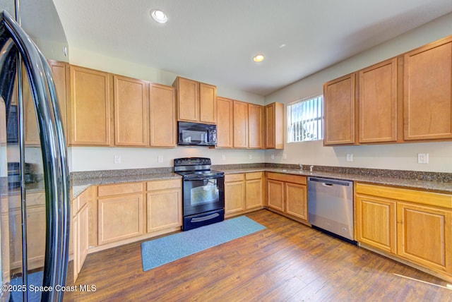 kitchen with recessed lighting, dark wood finished floors, black appliances, and light brown cabinetry