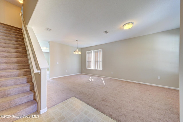 interior space featuring stairs, an inviting chandelier, baseboards, and light colored carpet