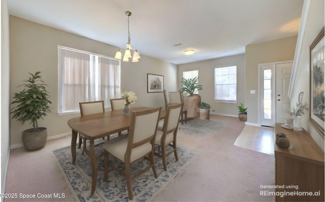 264 Wishing Well Cir SW, Palm Bay, FL 32908 - dining space featuring baseboards, carpet, and a notable chandelier