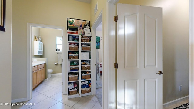 hall featuring light tile patterned floors