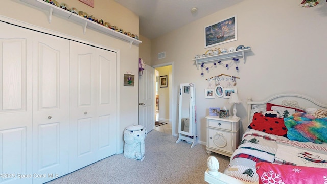 bedroom with light colored carpet and a closet