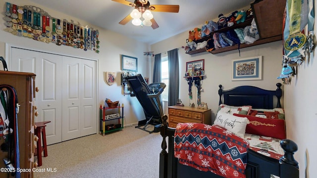 bedroom featuring ceiling fan, a closet, and carpet