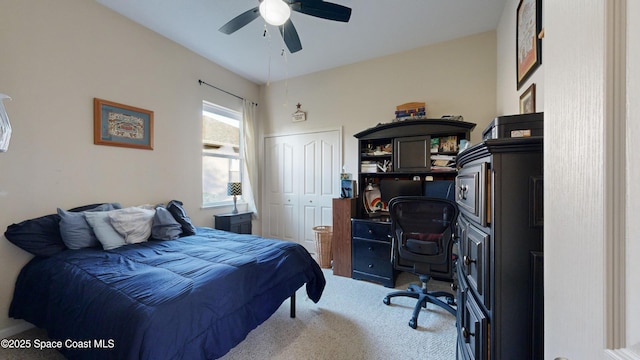 carpeted bedroom with ceiling fan and a closet