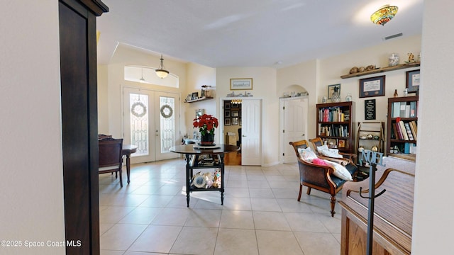 entryway with french doors and light tile patterned flooring