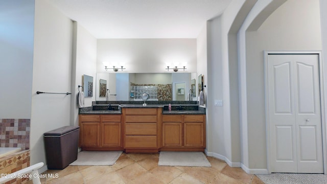 bathroom with vanity and independent shower and bath