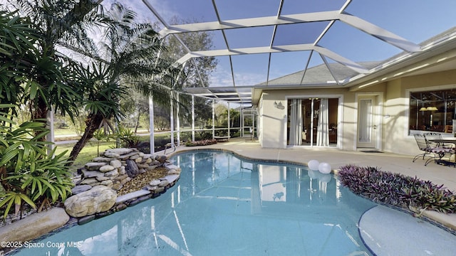 view of swimming pool with glass enclosure and a patio area