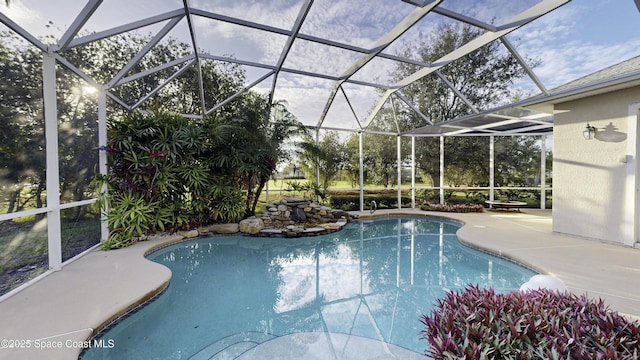 view of swimming pool with a lanai and a patio area