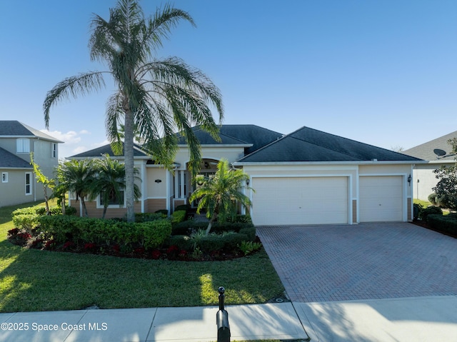 view of front of property featuring a front yard and a garage