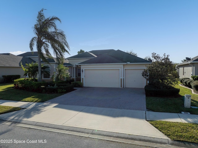 view of front facade with a garage and a front yard