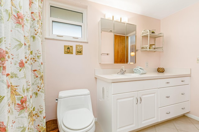 bathroom with vanity, tile patterned flooring, and toilet