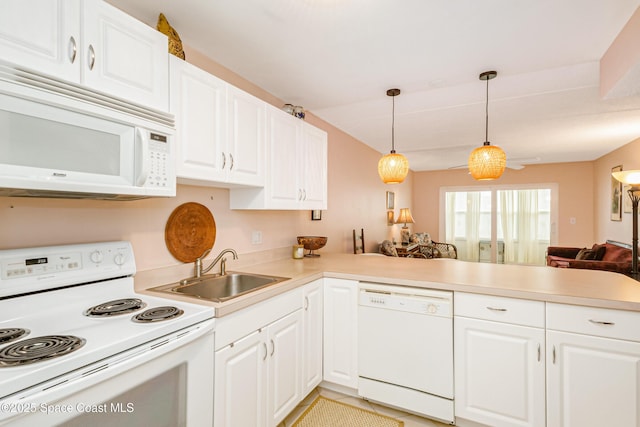 kitchen with hanging light fixtures, white cabinetry, sink, and white appliances