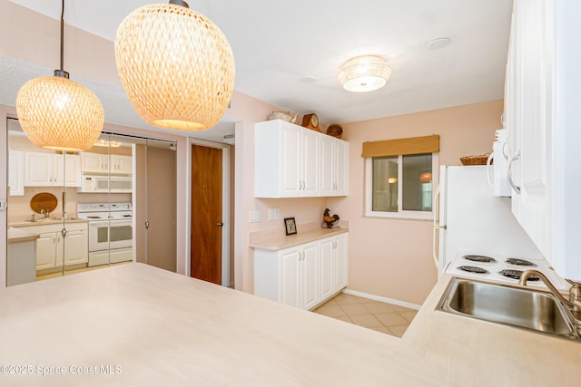 kitchen featuring light tile patterned flooring, sink, pendant lighting, white appliances, and white cabinets