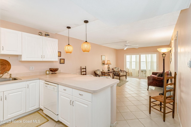 kitchen featuring dishwasher, sink, white cabinets, and kitchen peninsula