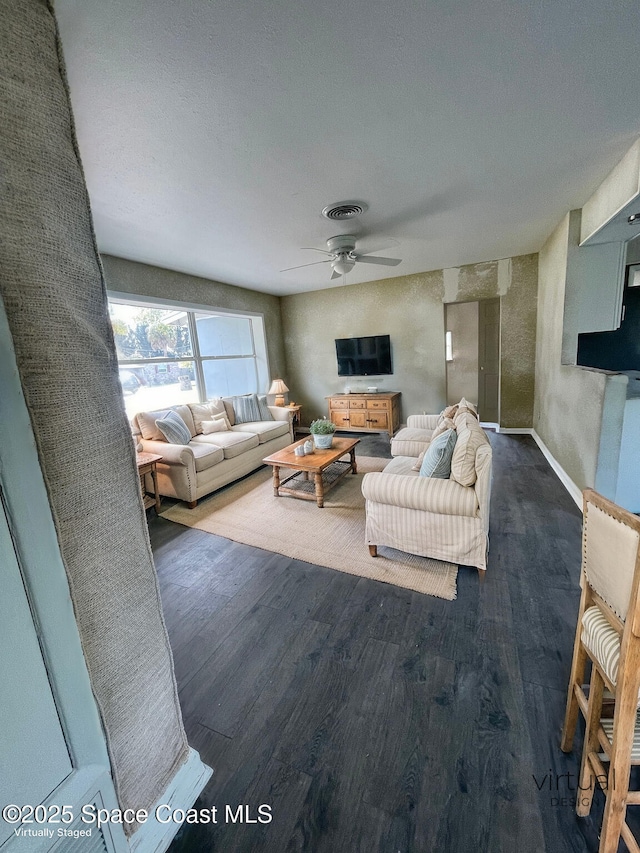 living room featuring ceiling fan and dark hardwood / wood-style flooring