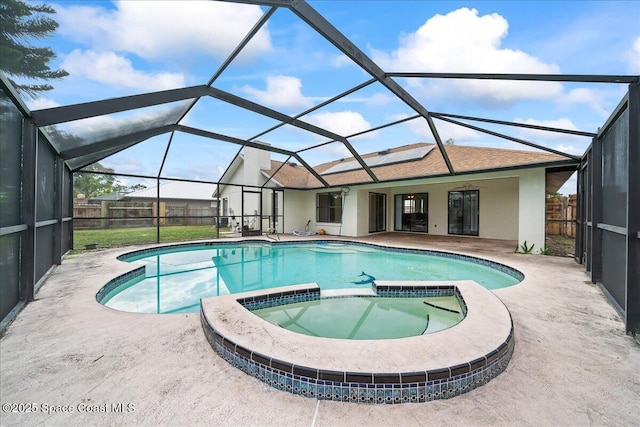 view of swimming pool with an in ground hot tub, a patio area, and a lanai