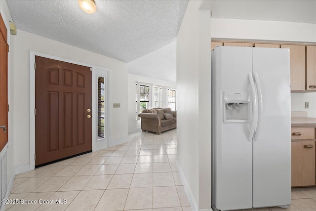 tiled foyer entrance with a textured ceiling